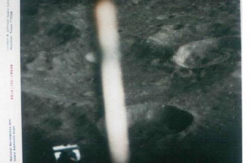 <p align=left> 一个修长而且发白光,形状像香烟的“飞船”在月球一个陨石坑上方盘旋。当然,这可能只是一道反光。这张照片是“阿波罗16”飞船1972年4月20日在月球上登陆前拍摄的。照片的左下方是这个登陆器的一只脚。</p>