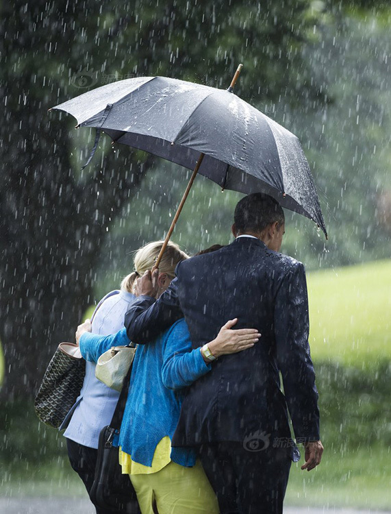 奥巴马雨中与女官员亲密撑伞照