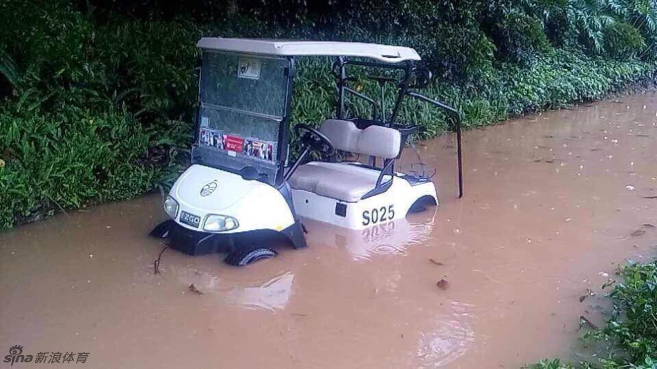 大水淹没球车场，数台白色球车像船只一样搁浅在停车场，积水几乎没过轮胎，形成一片孤岛。