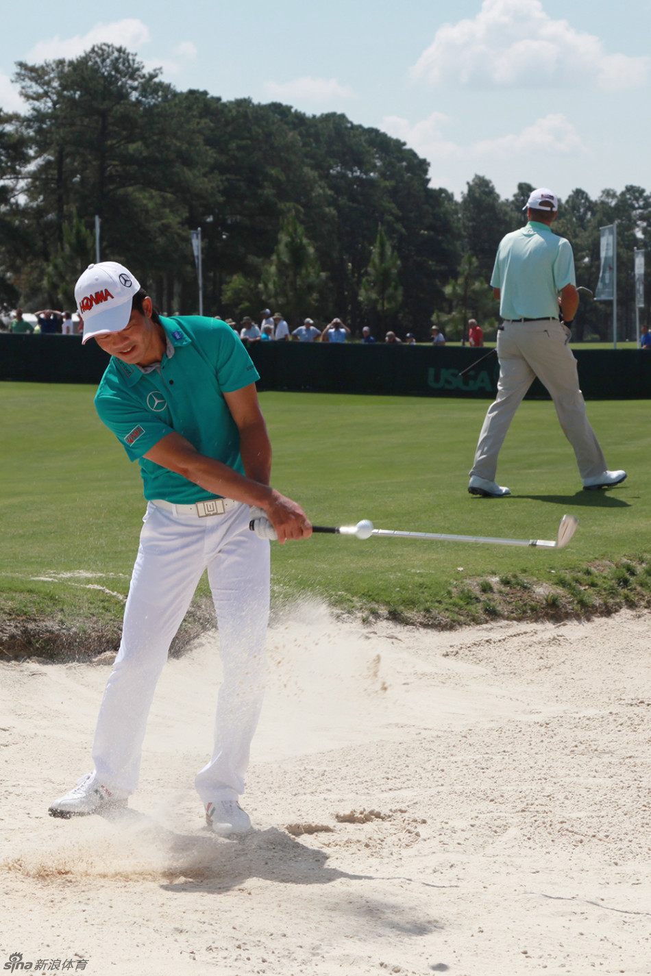 梁文冲在果岭上专注推杆，目光如炬锁定小白球