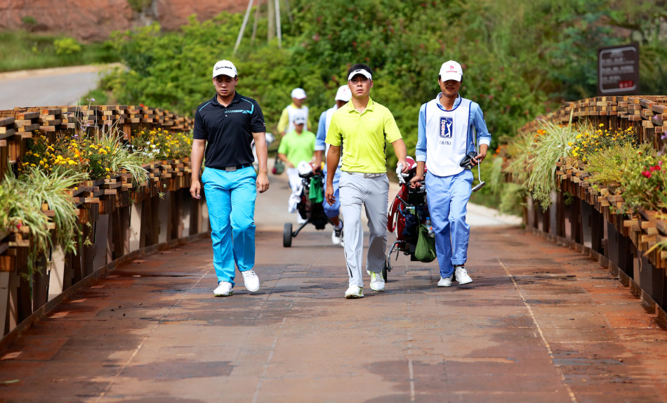 张新军完成前九洞比赛后正在转场，神情沉稳，步伐坚定，展现出不受外界干扰的专注。