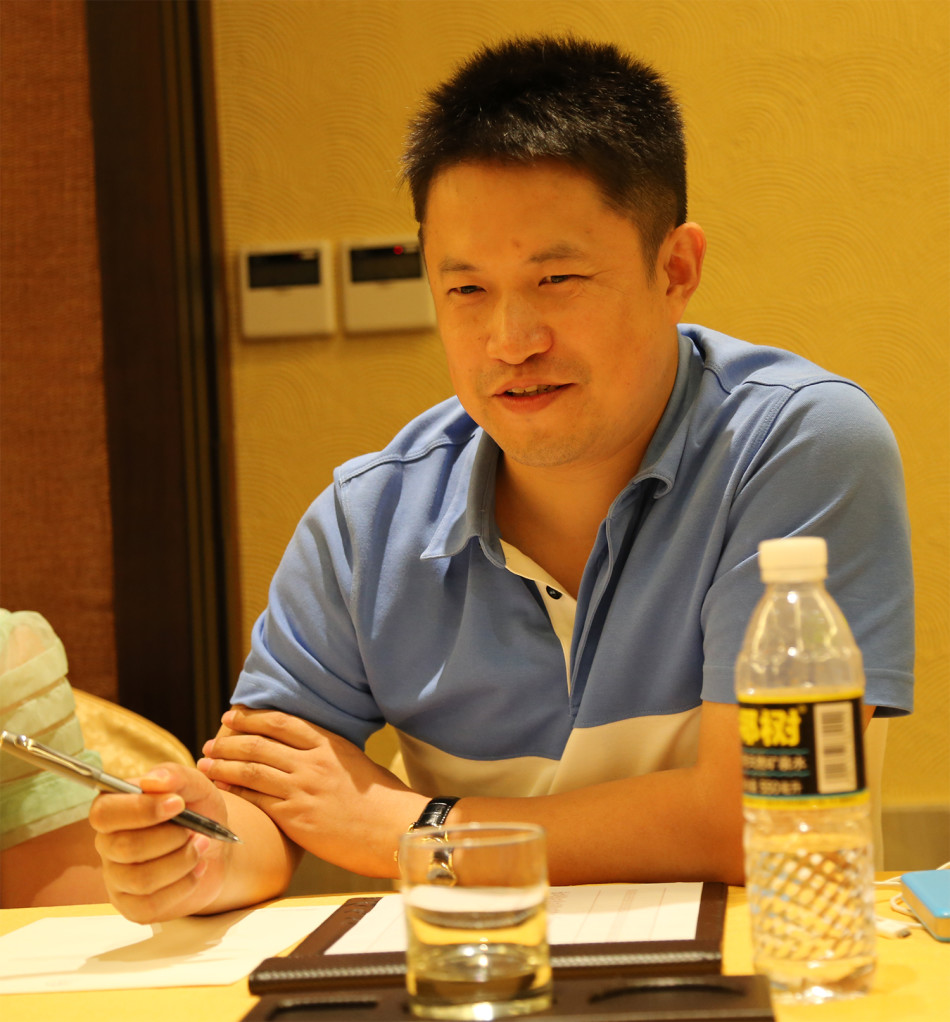 李琪在台上分享观点，她神态自若，语言流畅，身后的灯光洒落肩头，营造出既专业又温暖的氛围。