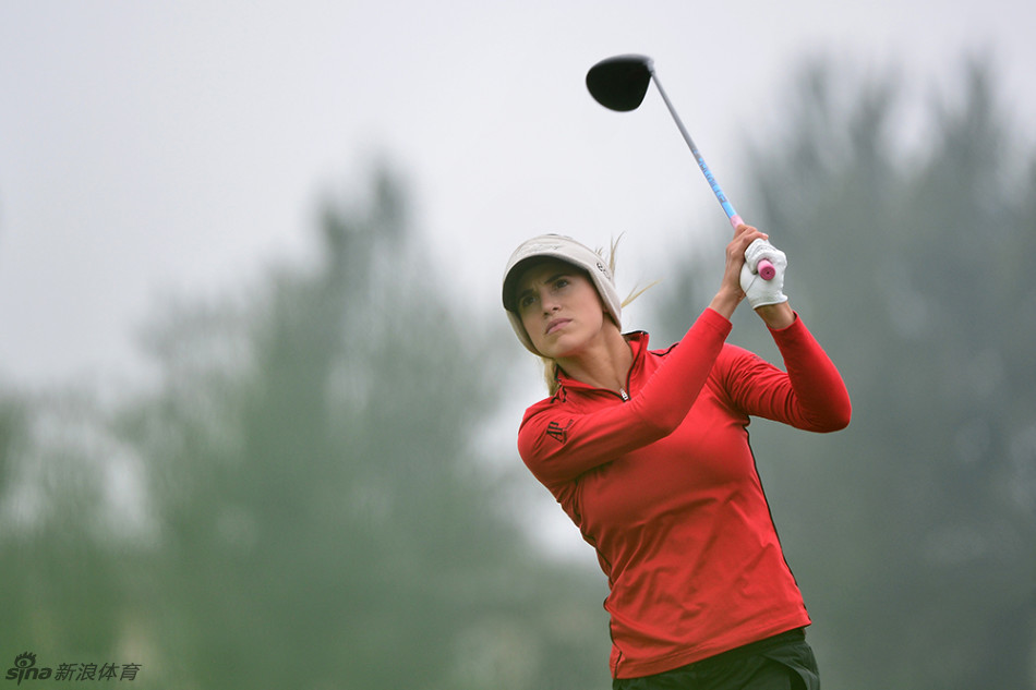 史黛西·路易斯在全神贯注地观察果岭地形,她沉稳的面容与坚定的眼神,预示着一次决定性的推杆。