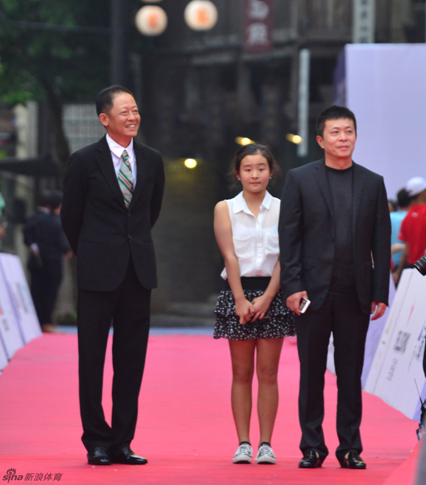 影帝陈道明与导演冯小刚并肩走在红毯上，两人正在轻松交谈，画面充满了老友间的默契与气场。