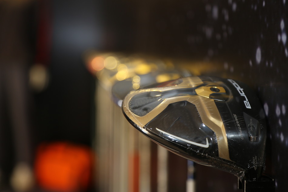 土豪金高尔夫球杆特写,金属光泽在灯光下流淌,彰显奢华与科技感