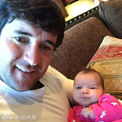 巴巴-沃森慈爱地凝视怀中女儿，父女间流淌着静谧而深厚的温情。