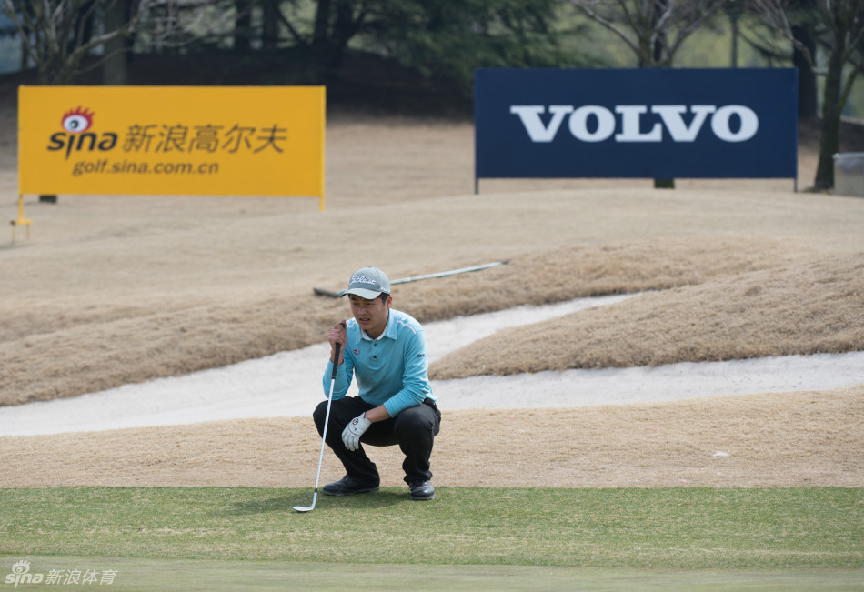 吴伟军全神贯注研读果岭走向,为关键一推做最后测算