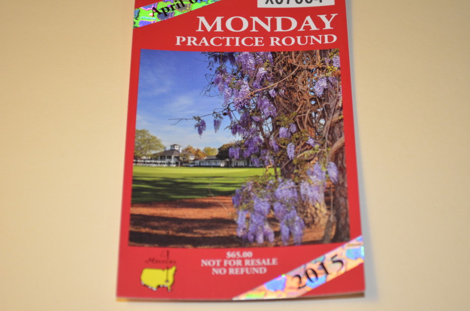 一套珍贵的2015年美国大师赛周一至周三练习轮门票,静静躺在深色背景上,是通往高尔夫圣殿的宁静序章。