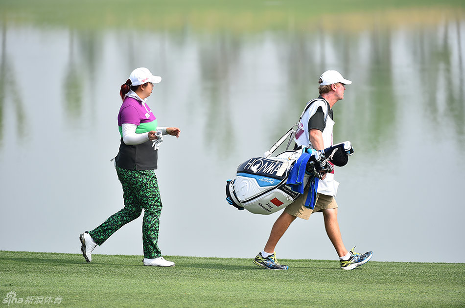 郭彩竹微微屈身，从球洞后方仔细审视果岭上微妙的起伏变化。