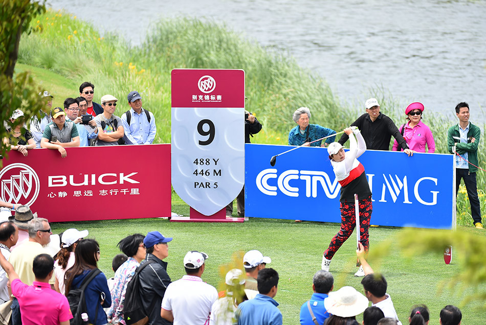 冯珊珊与球童在球道上并肩前行，认真商讨战术，两人的默契是赛场上一道信任的风景线