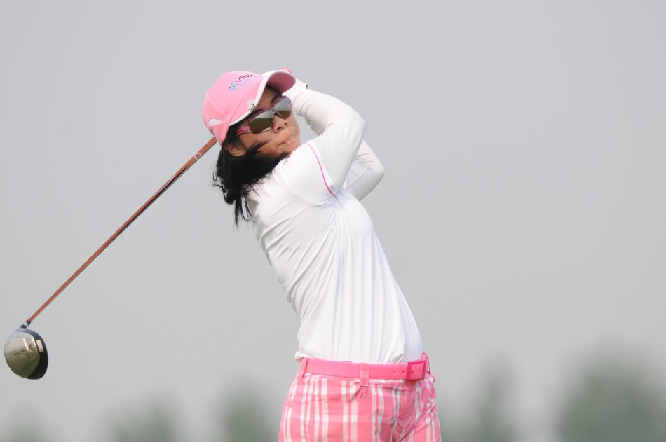 球员蔡欣儒在发球台上准备击球，她的姿态放松而专注，目光锐利地锁定目标方向，即将启动充满力与美的挥杆序列。