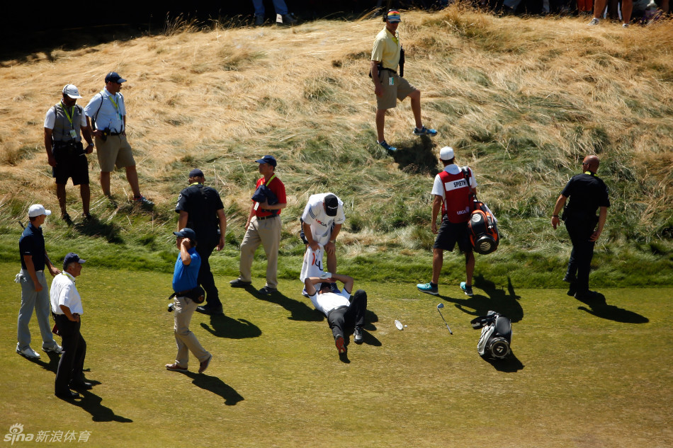 戴伊突然身体失控，向左侧踉跄倾倒，双手本能地伸向地面试图支撑。