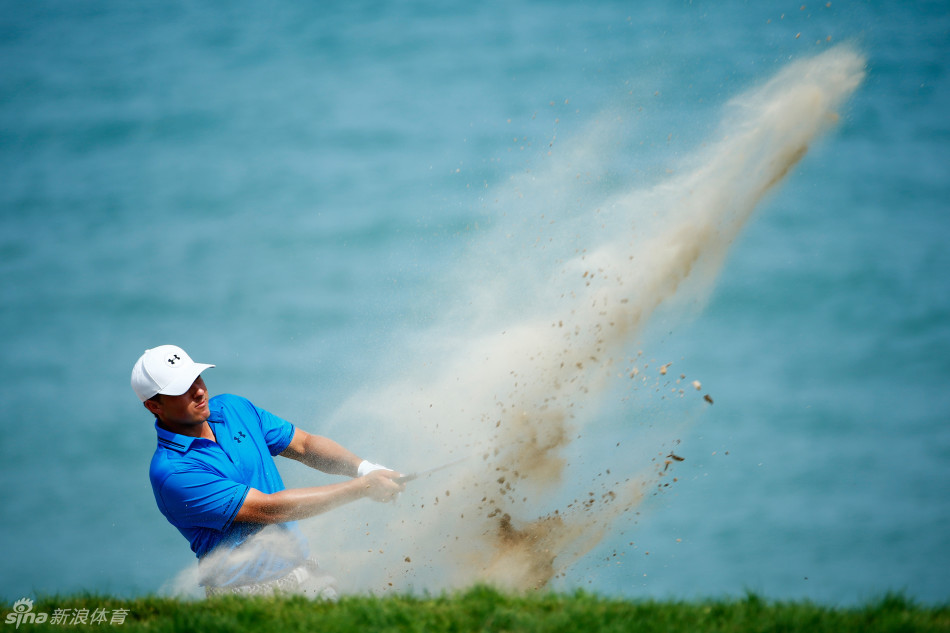 乔丹·斯皮思在沙坑中全神贯注救球，沙砾飞扬瞬间展现其精湛的短杆技术