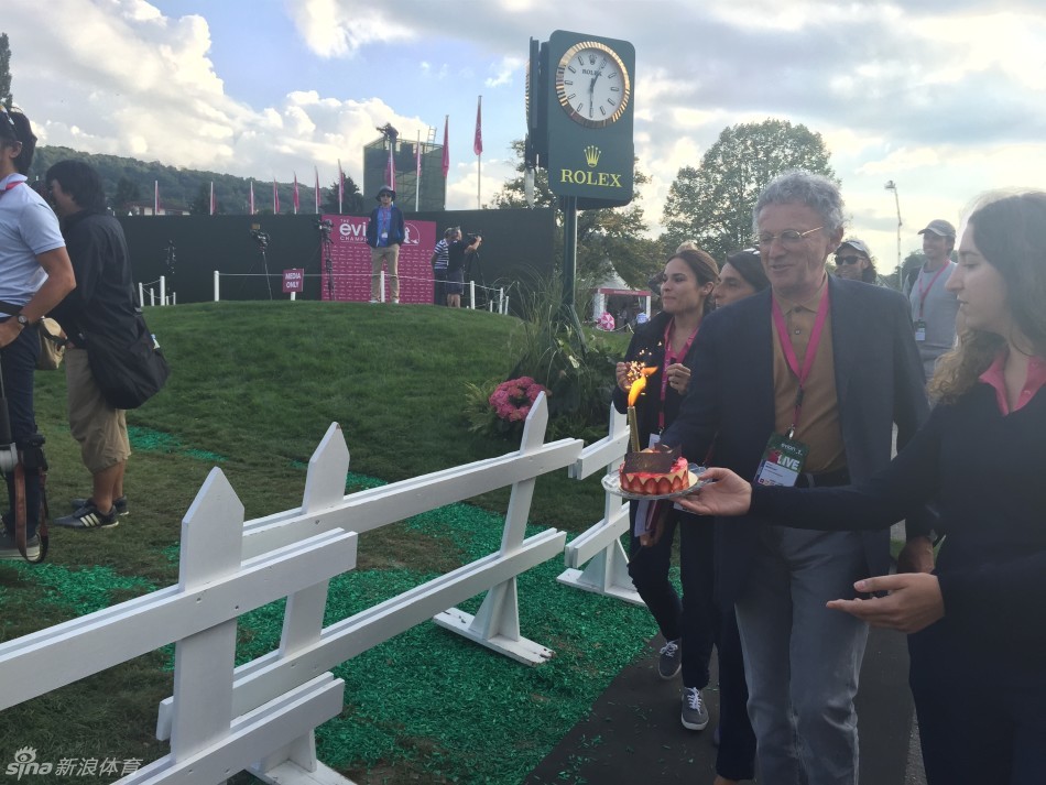 布鲁克·亨德森惊喜地凝视着眼前突然出现的生日蛋糕，眼神中满含喜悦与感动。