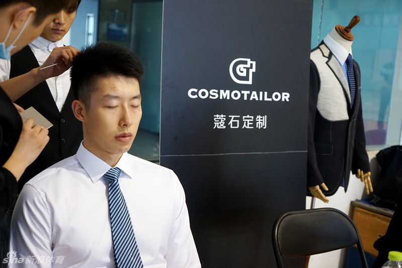 全队换上正装后的合影，球员们按照身高一字排开，双手抱胸，目光坚定地望向前方，仿佛一座由东方巨人组成的黑色城墙，庄严而不可撼动。