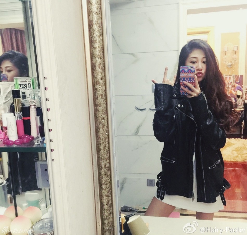 在另一组照片中，李跑换上优雅的裙装，依靠在栏杆边，眼神温柔地望向远方，修长的身材比例完美展现，宛如一幅动人的油画。