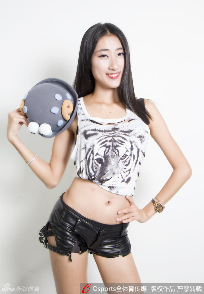 近景镜头下，一位宝贝轻抚着老虎背心上的纹路，眼神专注地望向赛场。这身虎纹战袍不仅是一件演出服，更承载着对球队勇猛无畏的深切期许。