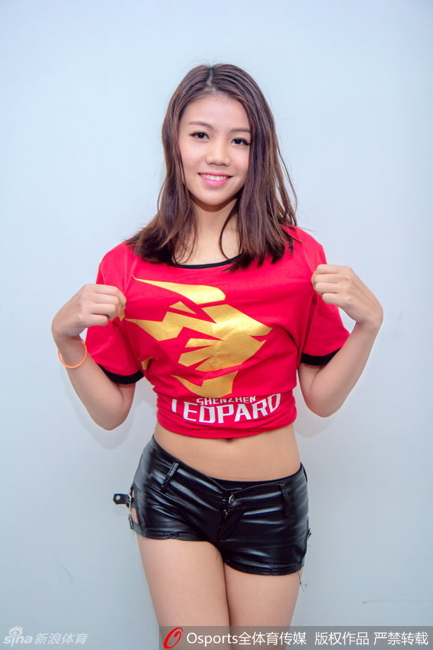 两位宝贝在场上相互整理妆容，侧颜线条精致，额前的碎发在灯光下泛着金光，显得既专业又亲和。