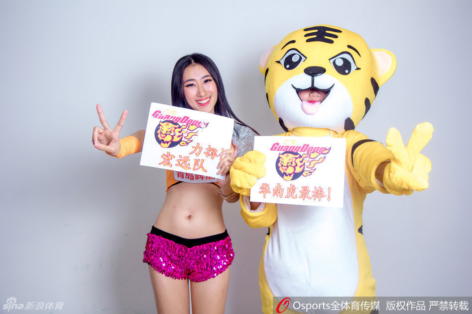 表演间隙，一位长发披肩的篮球宝贝亲昵地挽住吉祥物毛茸茸的胳膊，两人并肩而立，对着镜头绽放出灿烂的笑容，仿佛亲密无间的战友，共同守护着这片赛场的热血与梦想。