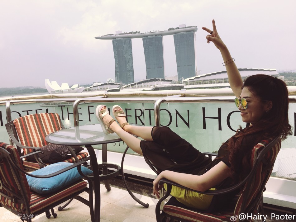 在极具特色的建筑前，李跑轻松秀出一双逆天长腿，身姿轻盈气质出众，引得路人纷纷侧目