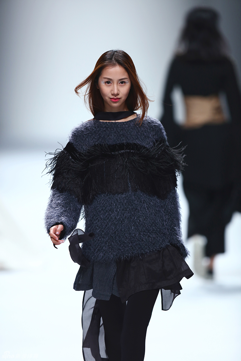 后台化妆间的灯光下，陈露端坐在镜子前进行补妆，手拿粉扑轻轻按压面部，神情专注而从容，展现出专业模特在幕后的严谨与敬业