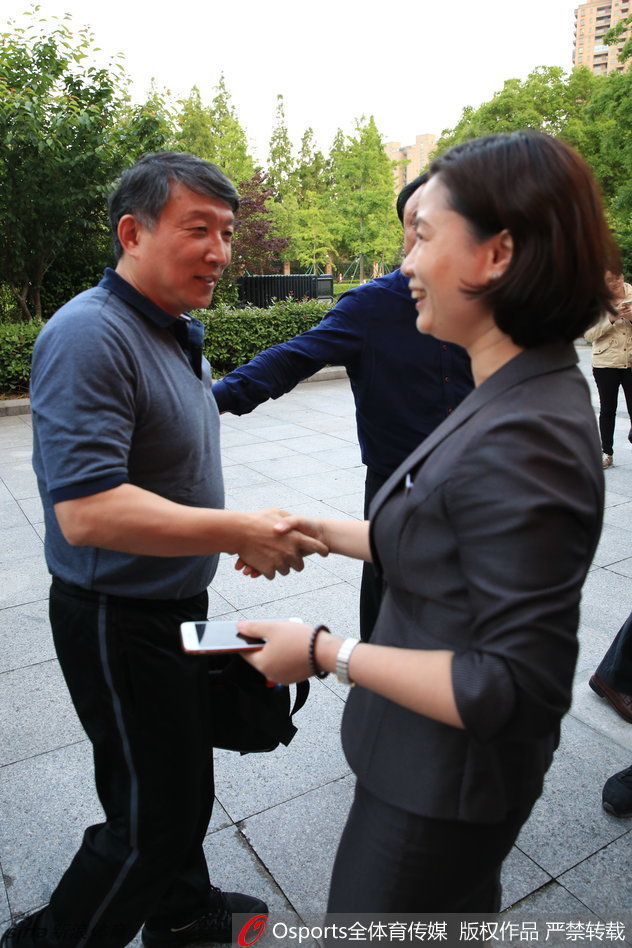 中国男篮领队柴文胜（左）与主教练宫鲁鸣（右）在场边交流，两人神情严肃认真，正讨论着下一阶段的训练重点。