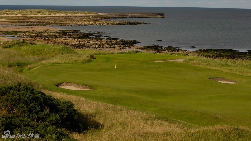 皇家多诺赫球场海滨日落：夕阳余晖染红天际，球道剪影延伸向宁静的北海