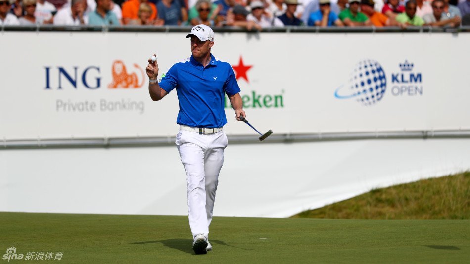 菲舍尔赛后与荷兰前高尔夫职业选手热情拥抱握手，面带灿烂笑容，体现赛场上的友谊与尊重