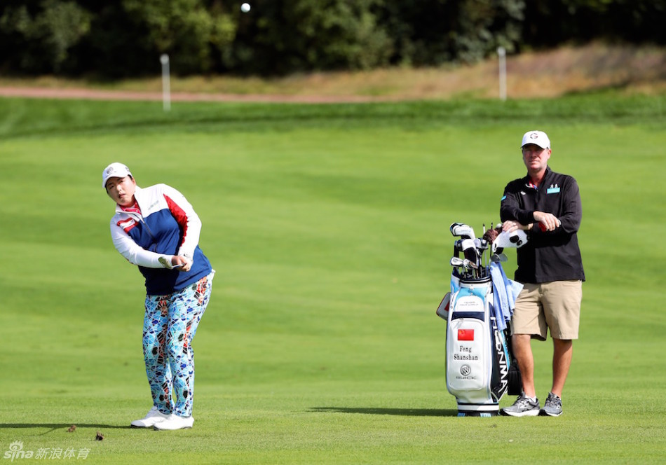 冯珊珊与父亲冯雄在球场小桥上漫步，父女二人正在专注讨论比赛策略