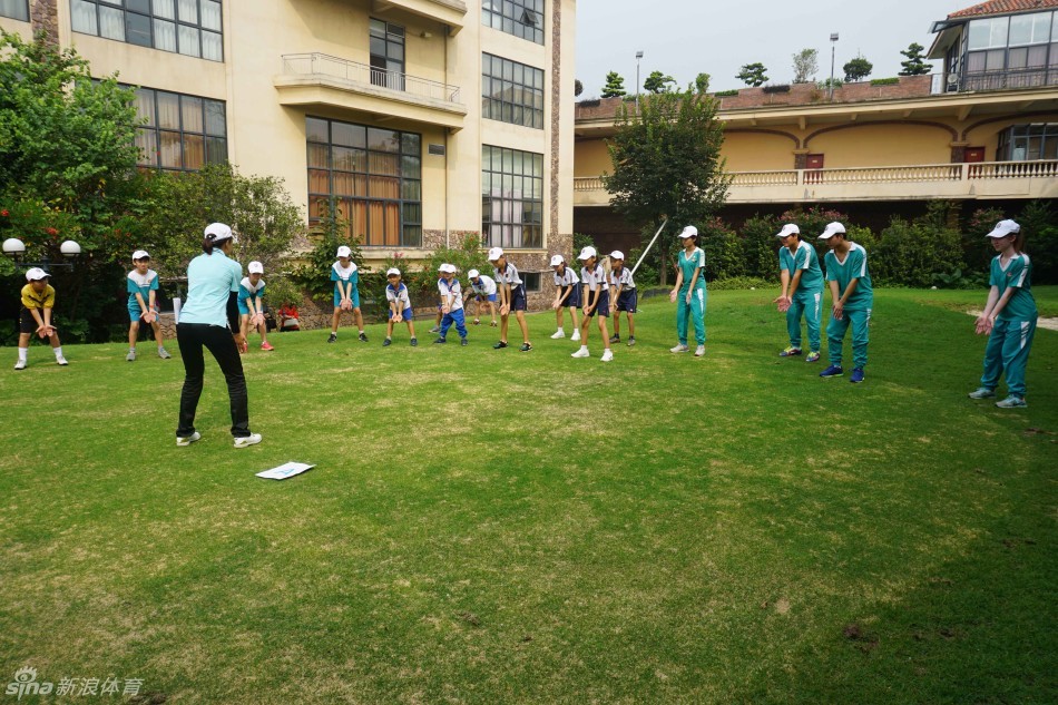 两名小选手在练习场并肩挥杆，动作协调有力，阳光下他们的身影勾勒出青春运动的优美剪影