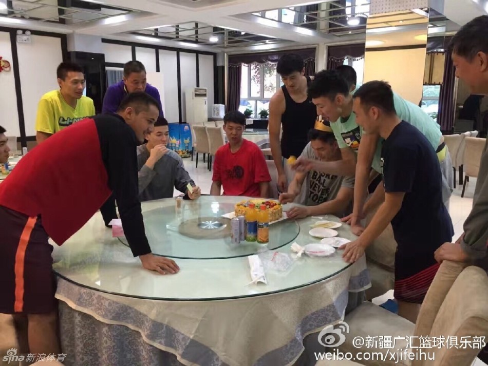 几个年轻伙伴围在寿星身后，有人举起双手跃跃欲试，脸上露出恶作剧得逞前的兴奋表情