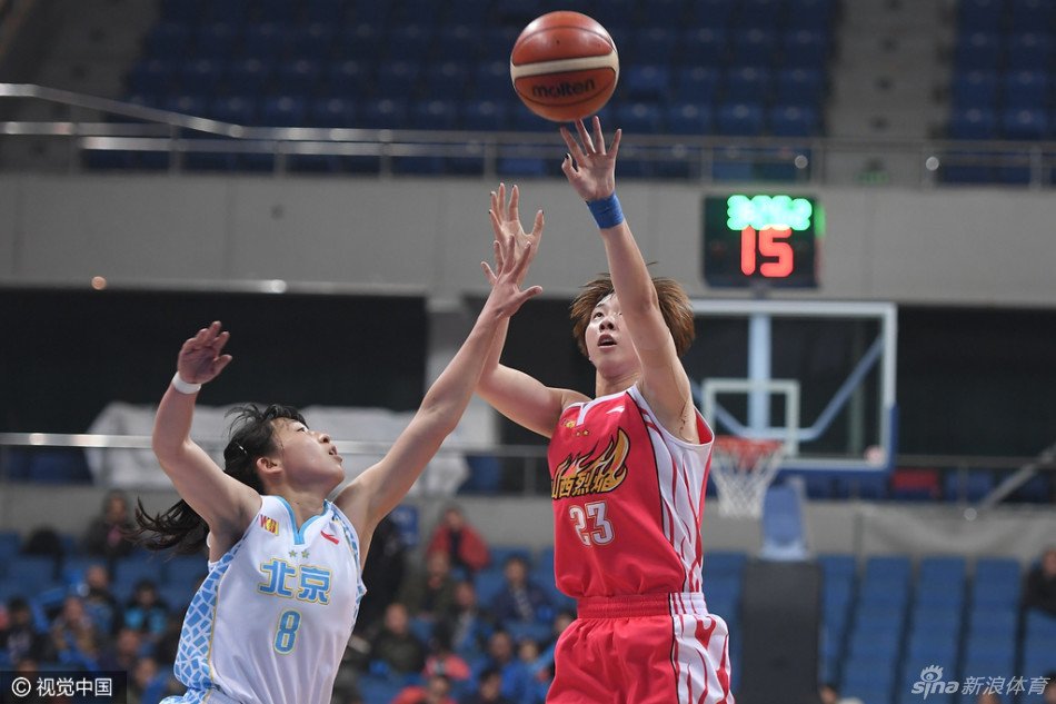 山西队球员奋力突破北京队的防线，她压低重心加速切入，眼神中透露出冲破阻碍的决心。