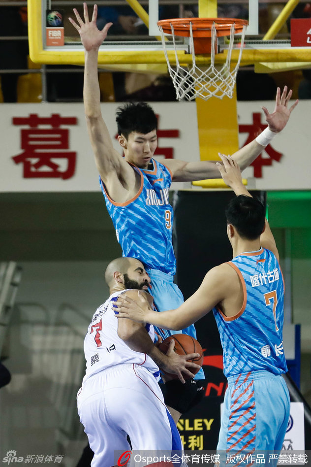 可兰白克在底角接球，面对扑防而来的对手，他眼神坚毅，从容出手三分。