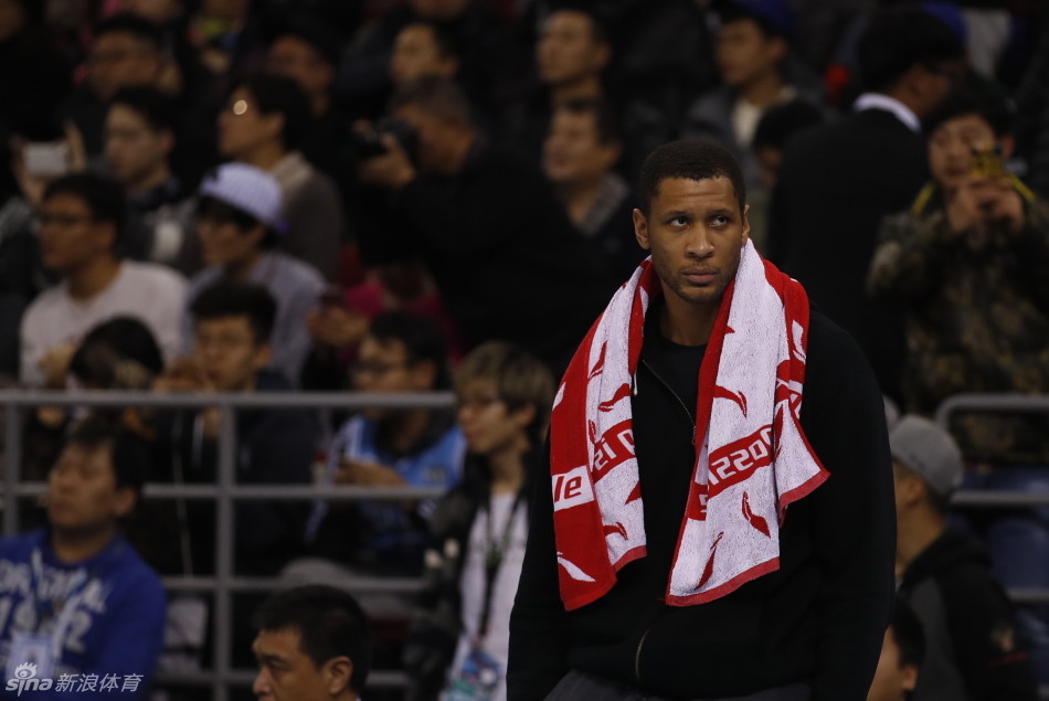 孙悦高举双臂干扰对手传球，脸上写满坚毅，在他身旁，莫里斯已经卡住位置准备拼抢篮板。