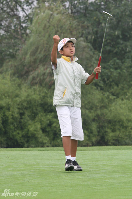 绿荫环绕的练习果岭上，小球员们正专注地进行推杆训练，态度一丝不苟。