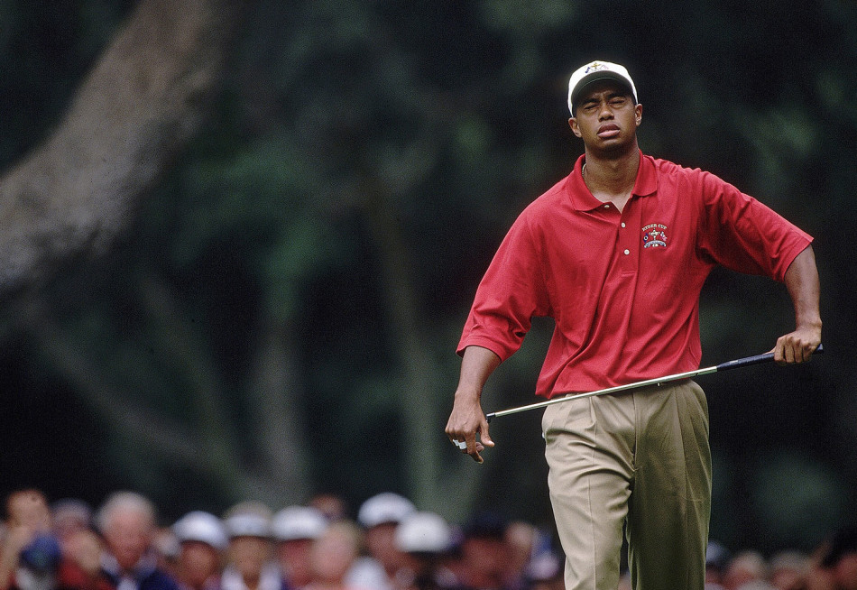 在万众瞩目的锦标赛颁奖典礼上，泰格·伍兹被璀璨的闪光灯包围，他手持奖杯，享受着属于冠军的荣耀时刻