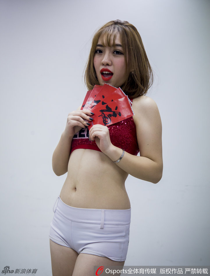 两位宝贝一起展示一幅精致的对联,上联是‘新春快乐’,她们眼中带着笑意,仿佛正在对镜头前的每一位球迷说出这句吉祥话