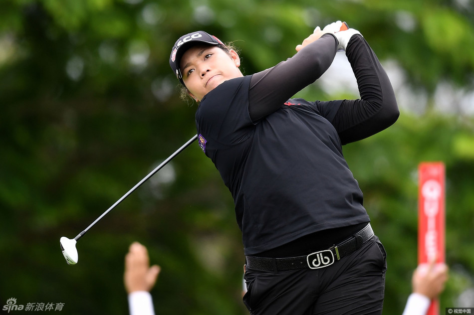 泰国名将阿瑞雅正专注地进行一号木开球，身姿挺拔充满力量，背景是暹罗乡村俱乐部典型的浓密绿荫。