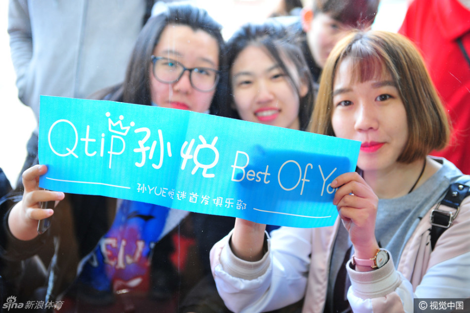 方硕在人群中露出灿烂的笑容，他正与身边一位身穿首钢队服的小球迷击掌互动，周围的球迷纷纷举起手机记录下这亲切的一刻