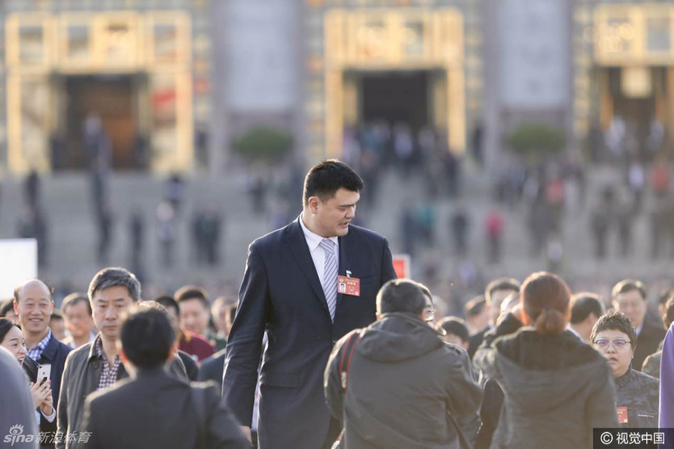 散会时分，夕阳余晖洒在广场上，姚明迈着从容的步伐走下台阶，其身影在光影中拉得更长，宛如一座移动的丰碑