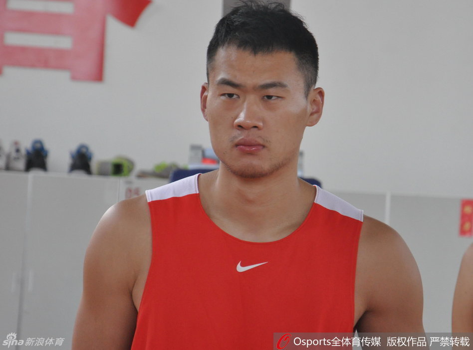 丁彦雨航在底角稳稳出手三分，篮球在空中划出完美弧线，背景是山东男篮训练馆的落地窗，阳光洒在地板上。