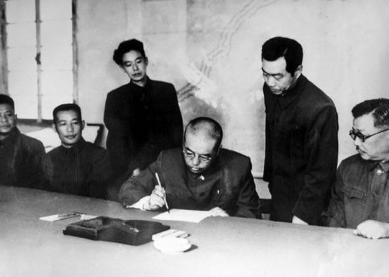 资料图:中国人民志愿军司令员兼政治委员彭德怀在停战协定上签字。