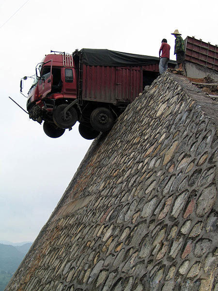 贵州超载货车冲出车道悬在半空