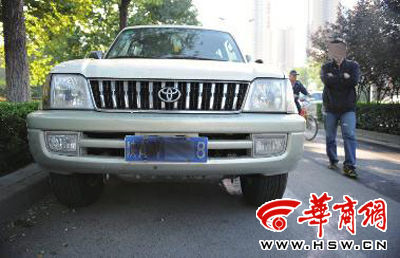 昨日下午4时，一辆私家车车主已将玻璃上的双面胶清理，但车牌上喷的黑漆还清晰可见 华商报记者 赵彬 摄