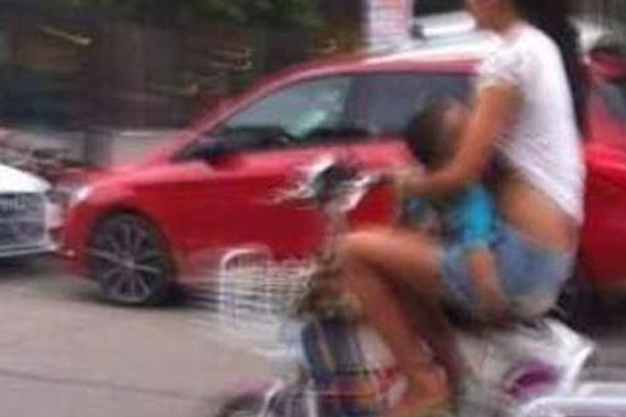 河南女子边骑电动车边给孩子喂奶