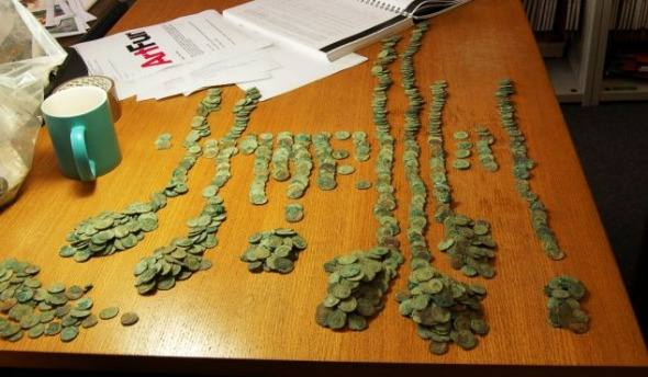 这些古钱币被分类摆放在桌子上。这次出土最重要的方面之一是有大量卡劳修斯钱币，卡劳修斯在公元286年到公元293年独立统治英国。