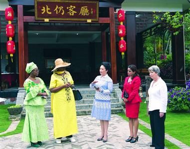 015年3月28日下午，彭丽媛向来宾们介绍海南开放式的传统民居建筑“北仍客厅”。　新华社