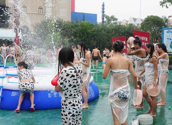 　　　百名辣妈身着性感的奶牛比基尼，在杭州一公园大玩泼奶狂欢(连国庆摄/光明图片)