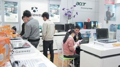 在长沙火车站附近某电脑城，担保公司员工正在向一名女孩(右二)推销电脑。周可 李姝阳摄影报道