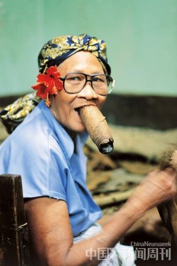 哈瓦那一家卷烟厂里抽大型雪茄的老妇人。抽雪茄是古巴人最热衷的爱好之一。